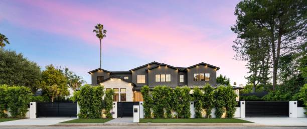 istock Modern luxury house with lush greenery and sunset sky. 2175972699