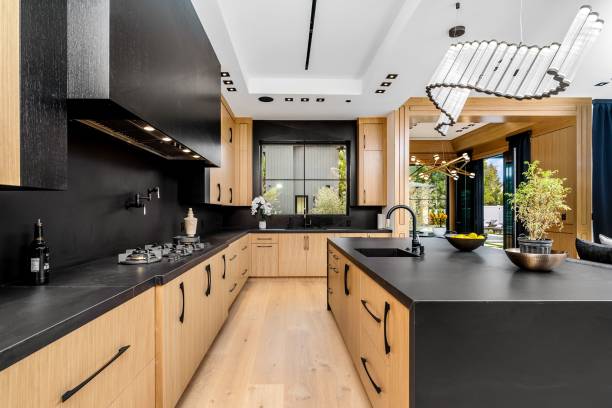 istock Modern kitchen with wooden cabinets and black countertops 2175972731