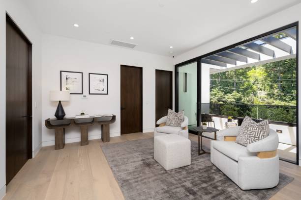 istock Modern living room with a view of lush greenery. 2175972804