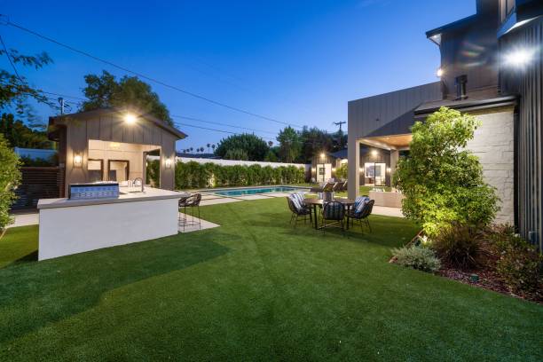 istock Modern backyard with outdoor kitchen and pool at dusk. 2175972858
