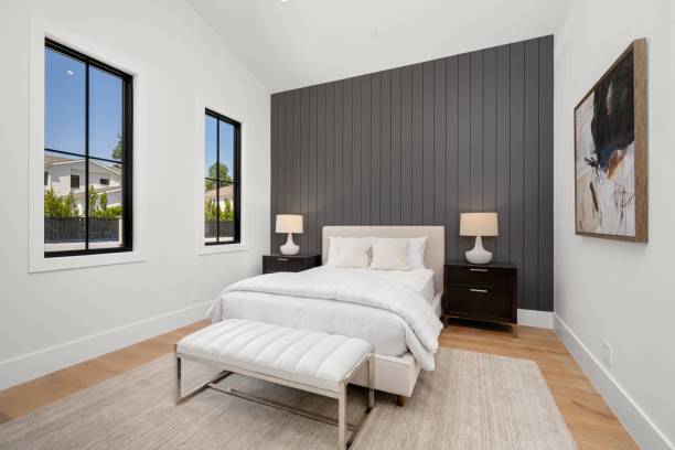istock Modern bedroom with gray accent wall and white bedding 2175972874