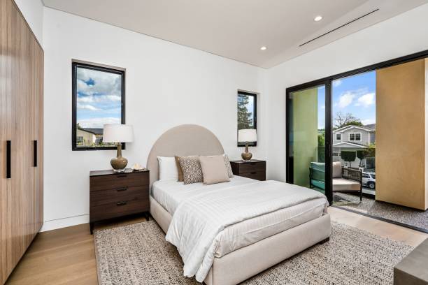 istock Modern bedroom interior with a cozy bed and large windows. 2175972879