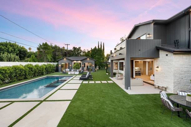 istock Modern home exterior with pool and seating under pink sunset sky. 2175972936