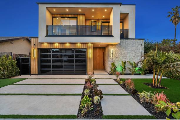 istock Modern two-story house with a landscaped front yard at dusk. 2175973012