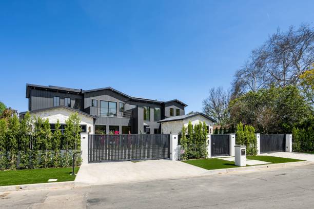 istock Modern luxury house with a large gate and manicured garden. 2175973075