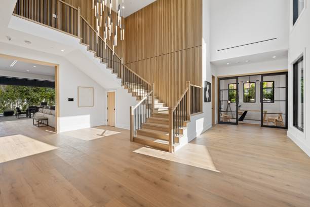 istock Modern home interior with wooden staircase and large windows 2175973610