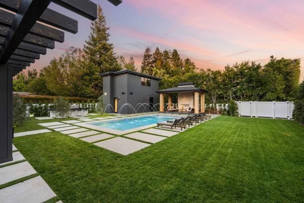 istock Modern backyard with pool and lounge chairs at sunset 2175973659