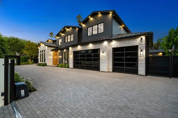 istock Modern luxury house with spacious driveway and well-lit exterior 2175973671