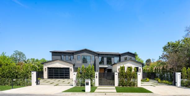 istock Modern luxury house with a large driveway and lush greenery. 2175973684