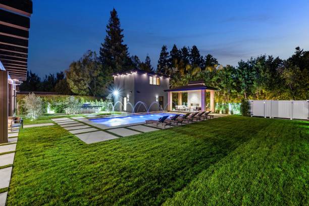 istock Modern backyard with illuminated swimming pool and patio area. 2175973689