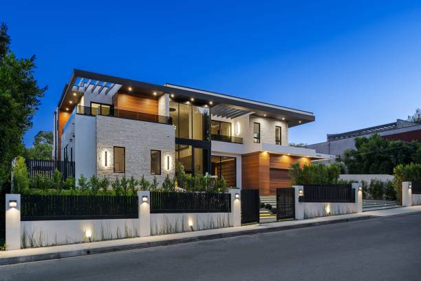 istock Modern two-story house with illuminated exterior at twilight. 2175973699
