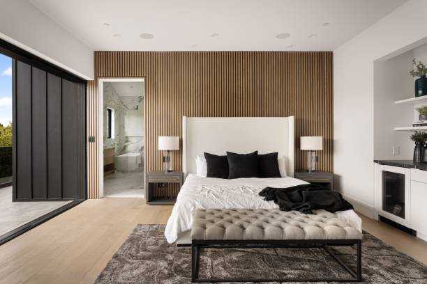 istock Modern bedroom with wooden paneling and luxurious bathroom view. 2175974201