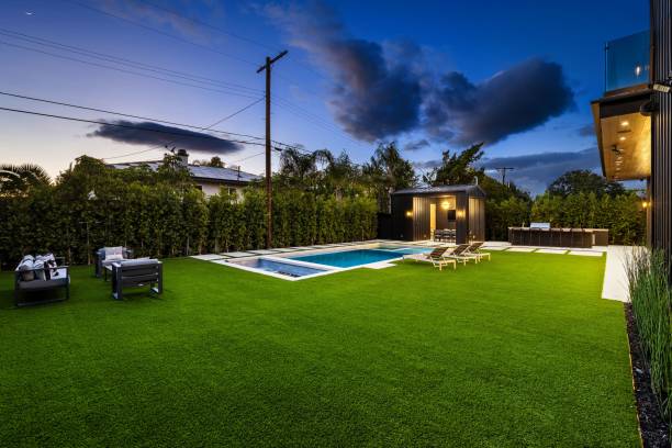 istock Modern backyard with pool and lounge chairs at dusk 2175974272