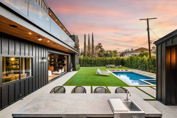istock Modern backyard with pool and outdoor kitchen at sunset. 2175974309