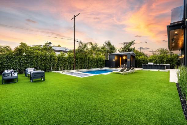 istock Modern backyard with pool and lounge chairs at sunset 2175974328