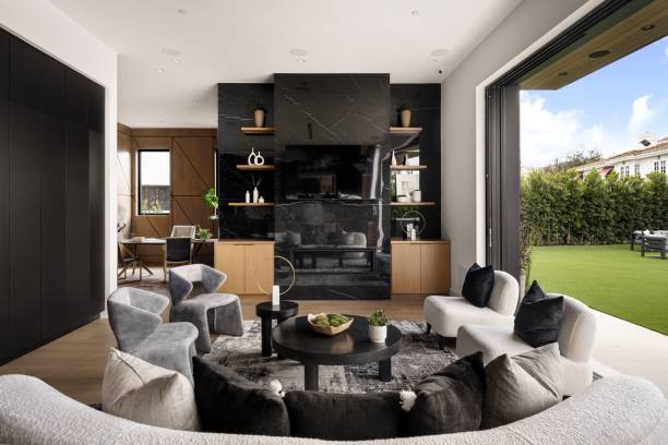 istock Modern living room with black marble fireplace and backyard view 2175974387