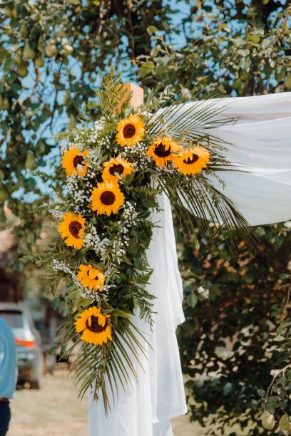 istock Wedding arch with sunflower decorations under a blue sky 2175974438