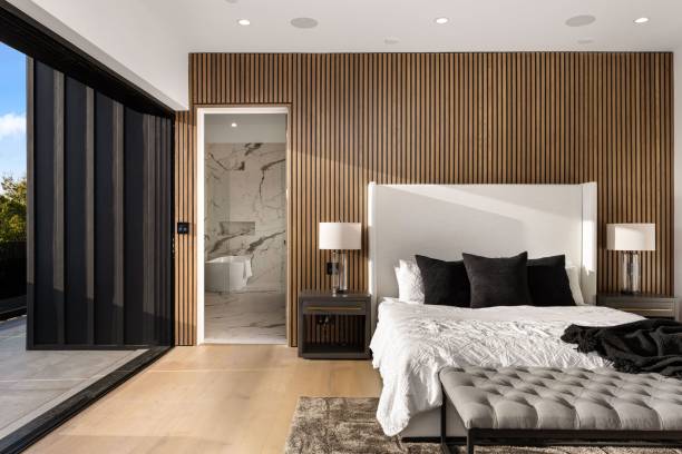 istock Modern bedroom with wooden accent wall and balcony view. 2175974466
