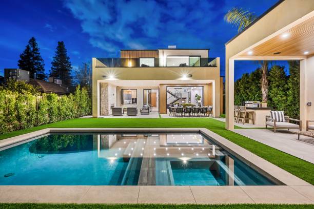 istock Modern luxury home exterior with pool at dusk 2175974689