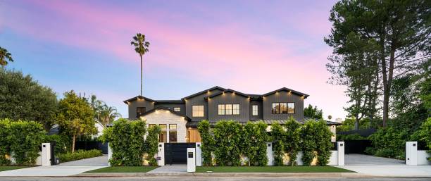 istock Modern luxury house exterior with lush greenery and a beautiful sunset sky. 2175974745