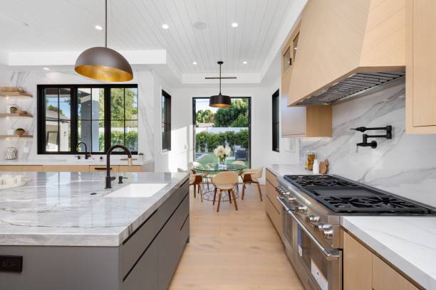 istock Modern kitchen interior with marble countertops and contemporary lighting. 2175974755