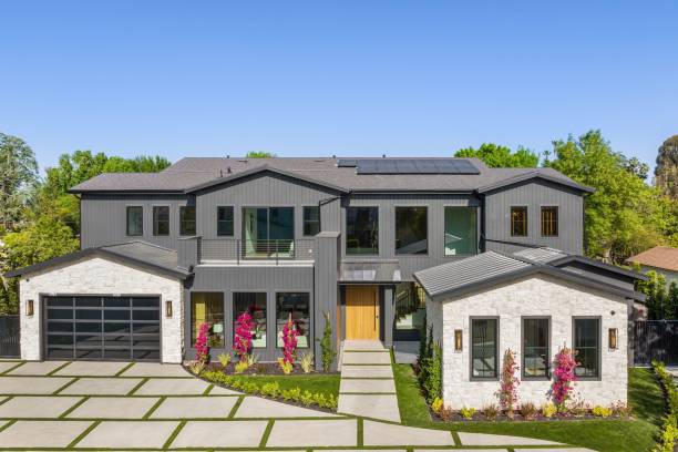 istock Modern two-story house with grey facade and large windows. 2175974768