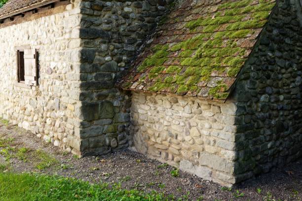 istock Old stone house with moss-covered roof 2175975436