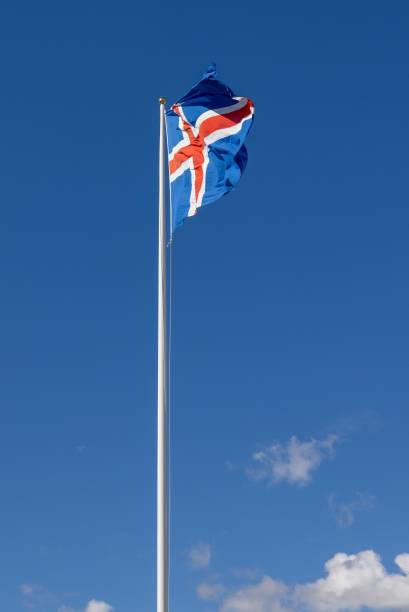 istock Icelandic flag waving on a flagpole against a clear blue sky with a few clouds. 2175975676