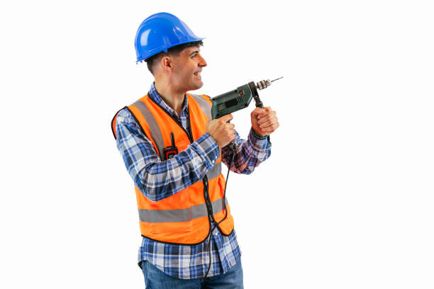 istock Construction worker drilling a hole in the wall, wearing orange reflective vest and safety helmet 2175978457