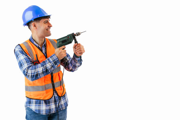 istock copyspace Construction worker actively drilling into the wall with safety gear on white background 2175978467