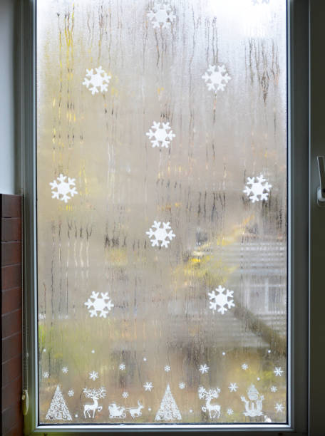 istock painted white snowflakes on the window glass 2175979933