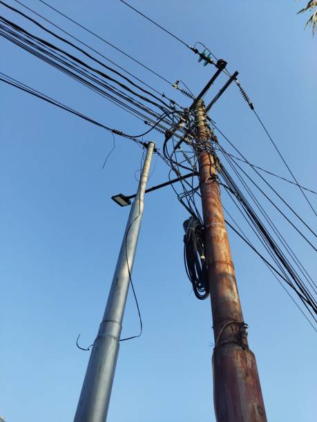 istock Electric and telephone lines on a pole with blue sky background 2175997635