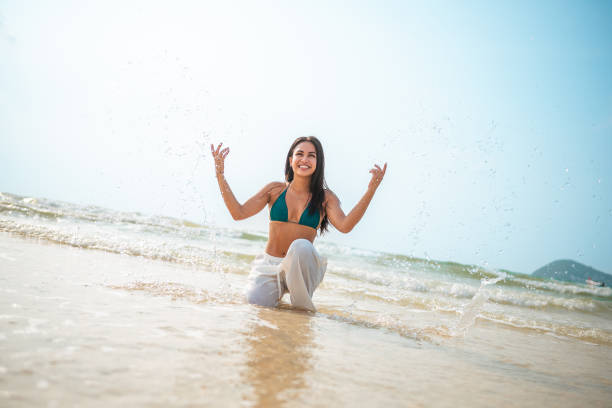 Tourist enjoying tranquility while meditating on the beach, absorbing the serene atmosphere of the sunset and the gentle sound of waves