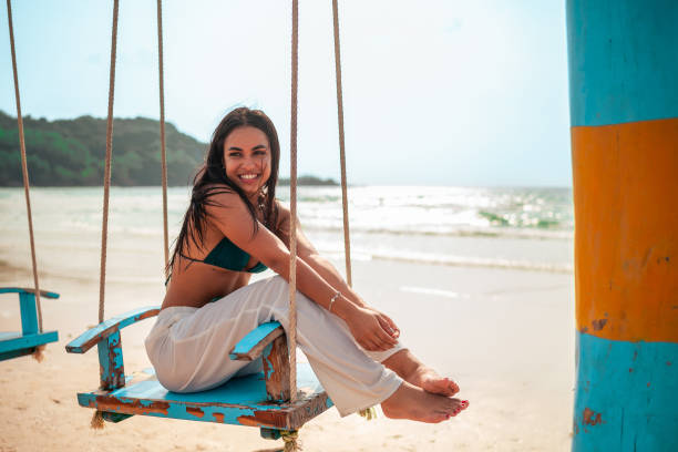 istock Joyful Hispanic Woman on Beach Swing 2176003228