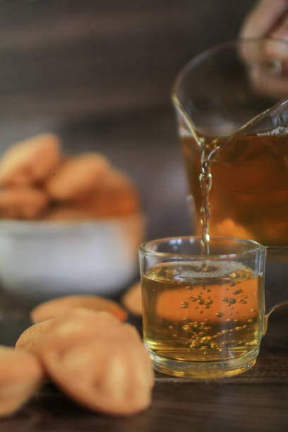 Hot tea drink with Mini castella cake, Traditional Thai egg cake or Khanom Khai made with egg and sugar, soft dough. Delicious local dessert