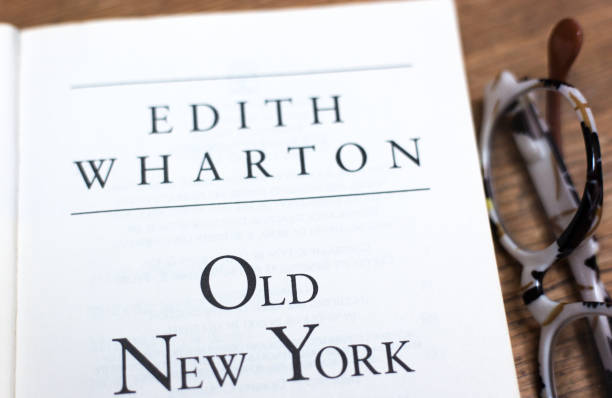 close-up of golden pen with old open book