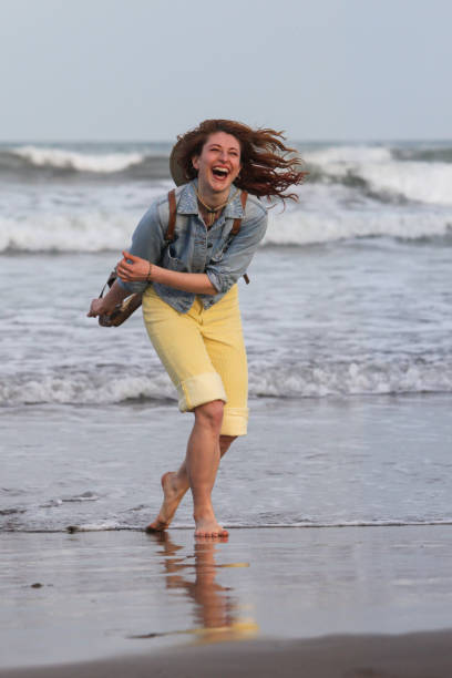 istock pretty joyful  woman having fun on the beach 2176022585