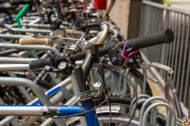 istock Old bicycle with worn handlebars parked in a row with other bikes 2176024032