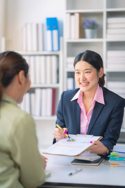 istock Two successful Asian businesswomen working with financial data graph documents and laptops in business data analysis. 2176024425