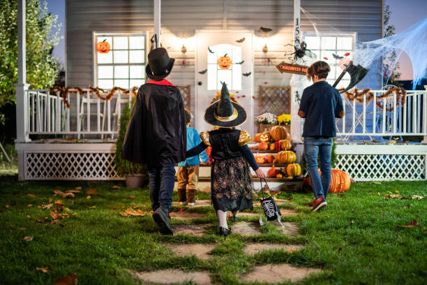 istock Young kids trick or treating at night during Halloween 2176024454