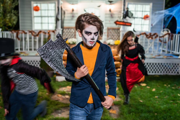 Young kids trick or treating at night during Halloween