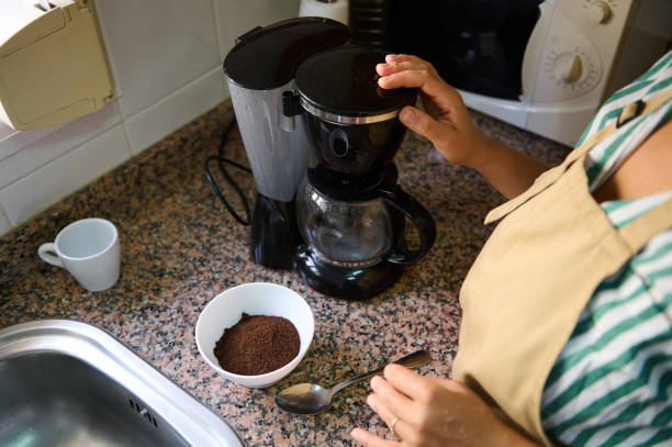 istock Person preparing coffee with a drip coffee maker in kitchen 2176024903