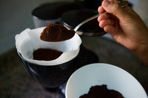 Close-up of coffee preparation with fresh grounds in filter