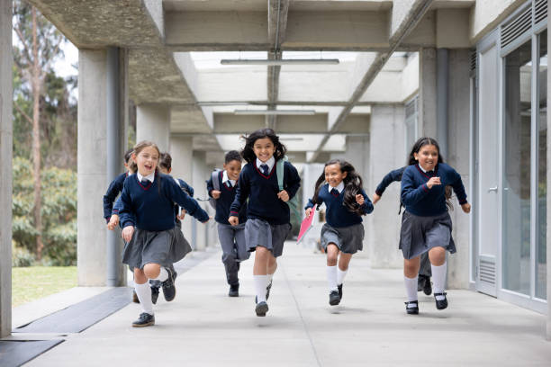 istock Happy young students running at the school corridor and going to their break 2176025148
