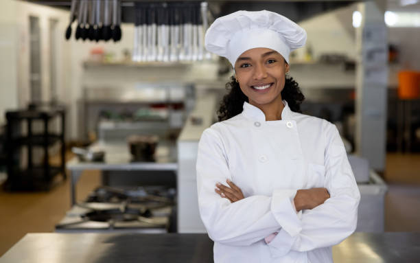 istock Happy chef working at a school cafeteria and smiling 2176025174