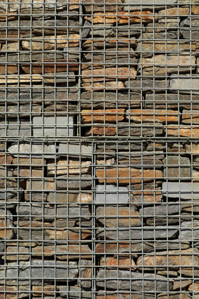 Fence with gabions and stones