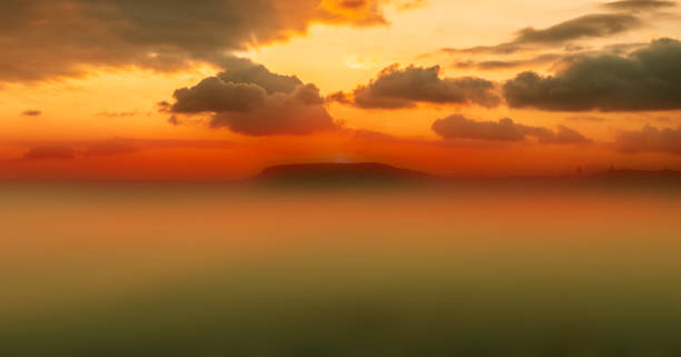 istock Landscape bright golden sunrise or sunset reflection mist over small island on pacific ocean background. Impressive nature scene of ocean. 2176040676