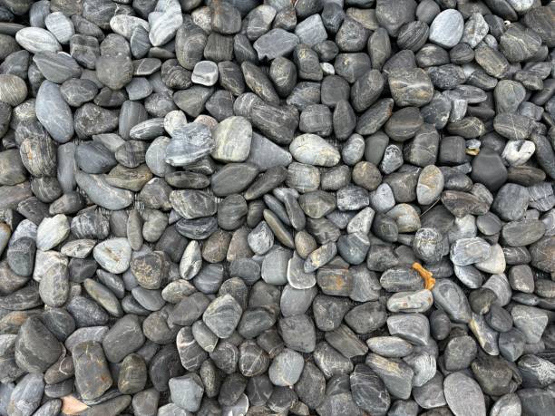 istock A collection of rounded grey pebbles arranged in a natural pattern. 2176047181