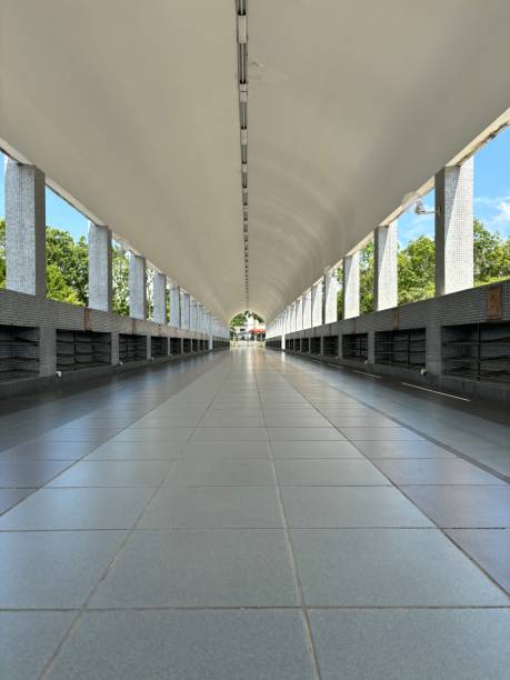 istock Covered corridor with tiled floors and open sides, offering a clear linear view towards an outdoor area. 2176047601