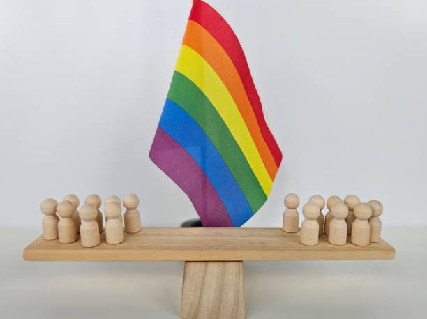 istock Colorful wooden figures gathered around a rainbow flag on a display platform celebrating diversity and inclusion concept 2176049034